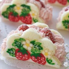 strawberry shortcakes decorated with icing on a doily