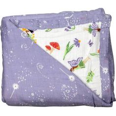 a purple blanket with flowers and butterflies on it, folded up in the shape of a triangle