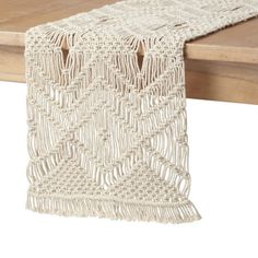 a white table runner on top of a wooden table