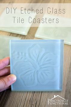 a hand holding a glass tile with the words diy etched glass tile coasters