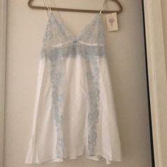 Appears White Satin With Baby Blue And White Lace .. 96% Polyester 4% Spandex Sheer Blue Sleepwear For Spring, Blue Cotton Camisole Sleepwear, Blue Cami Camisole For Daywear, Blue Camisole For Daywear, Blue Stretch Camisole For Loungewear, Stretch Blue Camisole For Loungewear, Blue Sleepwear With Built-in Bra For Summer, White Stretch Sleeveless Sleepwear, White Sleeveless Stretch Sleepwear