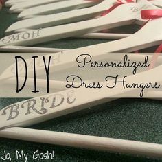 several pairs of personalized dress hangers with pink bows on them and the words bride written on them