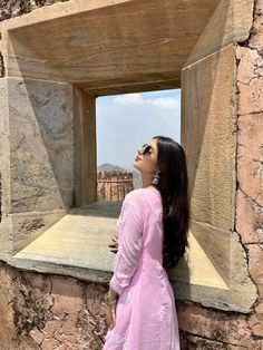 a woman looking up at the sky through a window