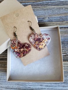 Beautiful natural rose petals in heart resin earrings. Hues of amber red paired with fiery copper flakes make these natural earrings boldly colorful. Bronze metal earrings with handmade resin heart pendants with real dried rose petals ♥ Be sure to check out the ORANGE EARRINGS section at EarringsbyLCreations for all beautiful orange colored earrings available! https://www.etsy.com/shop/EarringsByLCreations?section_id=28420987 Made with quality materials and always nickel and lead free metals. Na Handmade Heart-shaped Flower Earrings For Gift, Heart-shaped Flower Earrings For Mother's Day Gift, Resin Heart Earrings For Gifts, Pink Resin Heart Earrings As Gift, Pink Resin Heart Earrings For Gift, Valentine's Day Heart-shaped Flower Earrings For Pierced Ears, Heart Beads Earrings For Mother's Day Gift, Rose Gold Heart Earrings For Gift, Valentine's Day Flower Earrings With Ear Wire