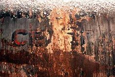 an old rusted metal surface with the word go written on it