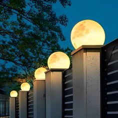 the moon shines brightly in the night sky over some concrete posts with lights on them