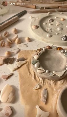 the pottery is being made and ready to be used in this art project with sea shells