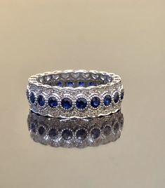 DeKara Designs Collection Metal- 14K White Gold, .583. Stones- Genuine Round Blue Sapphires 20-24 Round 1.60-1.90 Carats, 154-178 Round Diamonds F-G Color VS1-VS2 Clarity 0.60-0.85 Carats (Carat weight and Number of Stones Depends on your finger size) Size- 3-13 Band is 6.5 MM Wide and has a Height of 2 MM. Please indicate your specific size by sending me a conversation on etsy, or putting it in the notes of the transaction. Band will be made in your size within 5-7 working days. Will start work Elegant Sapphire Eternity Band With Round Cut, Elegant Blue Eternity Band, Formal Blue Sapphire Eternity Band, Elegant Sapphire Eternity Band With Brilliant Cut, Blue Round Eternity Band For Anniversary, Elegant White Gold Sapphire Eternity Band, Elegant Sapphire Eternity Band For Anniversary, Blue Round Cut Eternity Band For Anniversary, Blue Brilliant Cut Round Eternity Band