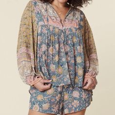 New With Tags, Spell Mossy Boho Blouse In Evening Size Xs. The Spell Mossy Blouse Is The Newest Take On A Classic Spell Blouse Fit. Featuring A Hand Drawn Mossy Ditsy Print With Florals That Dance In Hues Of Pink, Blue And Gold. Fits True To Size, It's Unlined And Crafted In An Uber Light And Floaty Blend Of 50/50 Lenzing Eco Vero Viscose And Organic Cotton. It Features A Bow That Can Be Left Loose Or Tied For A More Elevated Look. Lovely Pleats Adorn The Neckline And The Center Back Adding Some Flowy Bohemian Blouse For Loungewear, Spring Bohemian Loungewear Tops, Bohemian Relaxed Fit Blouse For Loungewear, Spring Bohemian Blouse For Loungewear, Pink Long Sleeve Blouse For Loungewear, Bohemian Long Sleeve Loungewear Blouse, Flowy Long-sleeved Tops For Loungewear, Flowy Long Sleeve Tops For Loungewear, Flowy Long Sleeve Blouse For Loungewear