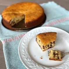 a piece of blueberry coffee cake on a plate with a fork next to it