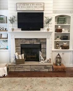 a living room filled with furniture and a flat screen tv mounted above a fire place