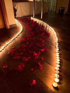 candles and rose petals are on the floor