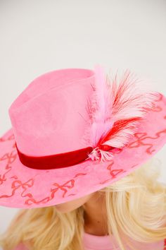 Unleash your inner cowgirl cutie with our WRAP SEASON PINK RANCHER HAT. Featuring a playful red bows print and a luxurious red velvet band, this pink hat is sure to turn heads. Plus, the added touch of pink, red, and white feathers adds a fun and unique flair. Saddle up and make a statement today! This hat is ONE OF A KIND, created by our owner Stephanie. To receive item quicker, expedited shipping is available at checkout. Red Velvet Band, Rancher Hat, Pink Hat, White Feathers, Red Bow, Pink Red, Red Velvet, Saddle, Feathers