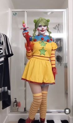 a woman dressed as a clown in a bathroom