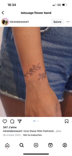 a woman's wrist tattoo with flowers on it