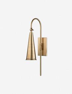 a brass wall light with a cone shaped shade on the top and bottom half of it