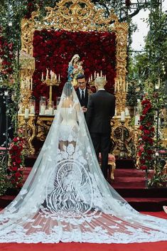 a bride and groom standing in front of a decorated altar