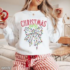 Christmas Light Bow Sweatshirt, Christmas Girly Shirt, Coquette Christmas, Xmas Gift, Holiday Sweater, Christmas Sweatshirt, Christmas Gift by LuckyLimeCo on Etsy Bow Sweatshirt, Bright Gifts, Shirt Coquette, Coquette Christmas, Tshirt Crafts, Sweater Christmas, Sweatshirt Christmas, Christmas Light, Holiday Sweater