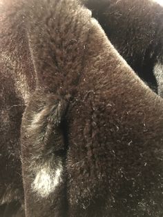 "Beautiful vintage faux fur coat is brown w/shawl collar, buttons up in front w/navy blue buttons, hidden leather detail inside, fully lined, pockets on sides. ( jeans not included) Good vintage condition. Minimal signs of wear. There is a hole on seam ( just in faux fur doesn't go through lining) about 1\" above both pockets ... seems intentional but not sure the purpose? ( see last photo for details) No brand, size or material label 'Clean by fur coat method' label inside Fits women's size: Sm Brown Fur Coat With Buttons For Fall, Brown Winter Fur Coat With Button Closure, Brown Fur Coat With Button Closure For Fall, Classic Brown Long Fur Coat, Classic Long Brown Fur Coat, Formal Brown Fur Coat For Fall, Classic Mink Outerwear With Faux Fur Lining, Brown Winter Fur Coat For Formal Occasions, Brown Faux Fur Coat For Cold Weather