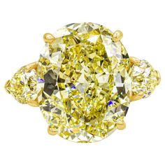 A well-crafted and color-rich three-stone engagement ring, showcasing a vibrant 13.46 carats oval cut yellow diamond certified by GIA as Fancy Intense Yellow color and VS1 clarity, set on a classic four prong basket. Flanked by two pear shape diamonds weighing 2.30 carats total certified by GIA as Fancy Intense Yellow color with VS1 and SI2 clarity, respectively. Made with 18K yellow gold. Created and stamped by Cartier. Oval Solitaire Ring, Unique Wedding Jewelry, Yellow Diamonds Engagement, Yellow Diamond Ring, Yellow Diamond Engagement Ring, White Sapphire Engagement Ring, Contemporary Engagement Rings, Oval Cut Engagement Ring, Oval Diamond Ring