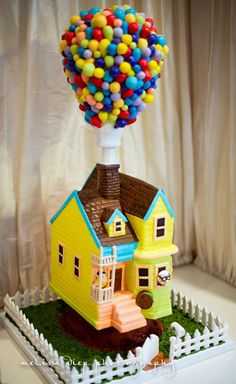 a house with a bunch of balloons on top of it