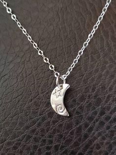 "Our sterling silver charm is on a 2mm, 18\" sterling chain.   The charm is roughly 1/2\" long..  This piece is handcrafted, so variations will occur.  Take pride in knowing that your piece is one of a kind. The Sterling Silver consists of 92.5% Silver and 7.5% of an alloy, mainly consisting of copper.  In some, the copper reacts with the skin and can turn it green. NOTE:  Each piece is in its natural state. It's not coated with anything to prevent tarnish.  Oils, lotions, moisture, etc. will accelerate the tarnish, so its recommended that you use a jewelry cloth for cleaning after wearing your jewelry.  Choking Hazard - Small Parts WARNING: CHOKING HAZARD--Small parts  Not intended for children. Although extremely rare, some people are allergic to the metals and finishes commonly used in Bronze Bangle, Boho Bangle, Celtic Pendant, Black Onyx Necklace, Brass Cuff, How To Clean Metal, Onyx Necklace, Stacked Bangles, Gold Cuffs