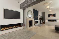 a large living room with a fireplace and flat screen tv mounted above it's mantle