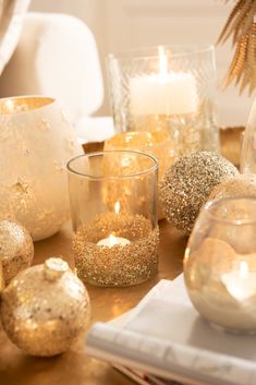 some candles are sitting on a table with other decorations