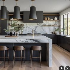 a kitchen with marble counter tops and wooden stools next to an island in the middle