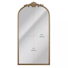 a large mirror with an ornate frame and gold trimmings on the bottom half