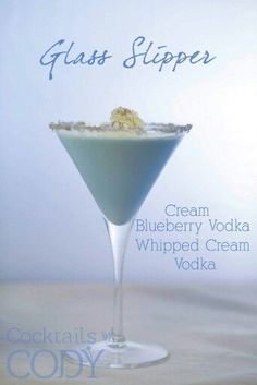 a blueberry vodka is garnished with whipped cream and crumbled sugar