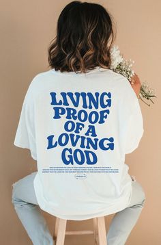 Introducing our new "Living Proof of a Loving God " t-shirt, a perfect expression of faith and style. This Christian shirt features a timeless design and a powerful message. This shirt is not only a fashionable choice but also a meaningful one. It serves as a reminder of the saving grace of Jesus Christ and the hope and redemption that comes with it. It's a great way to boldly express your faith and share your beliefs with others! ⁑ F U N ⁑ F A C T S ⁑ ☼ Unisex Adult Sizes ☼ 100% Cotton ☼ Washer Inspirational Short Sleeve Streetwear T-shirt, Inspirational Short Sleeve T-shirt For Streetwear, Bible Verse T Shirt, Jesus Clothes, Aesthetic Christian, Christian Shirts Designs, Christian Streetwear, Loving God, Christian Men