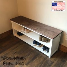 shoes are sitting on top of a shelf in a room with hardwood floors and white walls