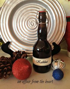 a bottle of beer sitting on top of a table next to christmas decorations and a plate