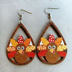 a pair of earrings with a turkey on it