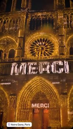 an image of a large building that is lit up with lights and the words merci on it