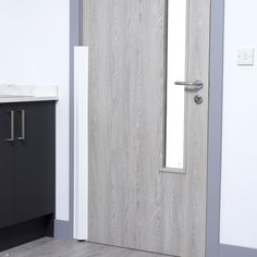 a bathroom door with a mirror on the wall next to a sink and toilet paper dispenser