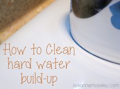 a close up of a bowl on top of a counter with text overlay that reads how to clean hard water build - up