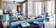 a living room filled with blue couches and chairs