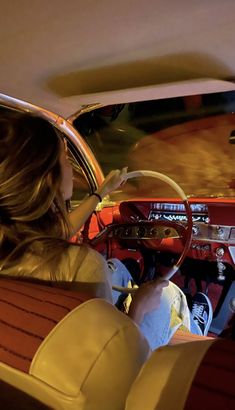 a woman sitting in the driver's seat of a car