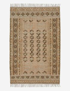 an old rug with fringes and designs on the bottom, is shown in beige