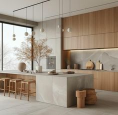 a modern kitchen with wooden cabinets and marble counter tops, along with bar stools