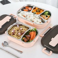 three bento boxes filled with different types of food and utensils on a table