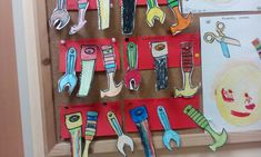 a bulletin board with lots of different types of scissors hanging from it's sides