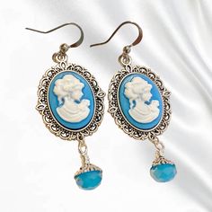 These adorable Victorian styled Cameo Earrings are designed using blue faceted crystals and enchanting acrylic cameos. The antique style silver cameo setting and bead caps in antique silver add that perfect touch of vintage detail. These classic earrings would make an exquisite birthday gift. These drops hang approximately 6cm from handmade brass ear wires. 🌿SIZE: approximately 4cm drop. 🌿MATERIALS: nickel and lead free wire, handmade ear wires, glass crystals, silver plated wire, resin. 🌿DES Luxury Victorian Cameo Earrings, Victorian Cameo, Cameo Earrings, Gothic Earrings, Victorian Lady, Classic Earrings, Handmade Brass, Cameo Pendant, Victorian Gothic