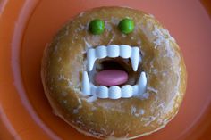 a doughnut that has been decorated to look like a monster's mouth and teeth