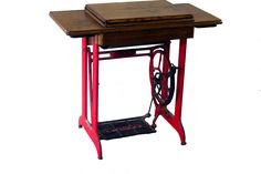 an old sewing machine sits on top of a small table that is turned into a workbench