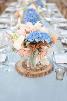 a long table with blue and pink flowers on it