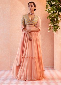 This set features an apple green embroidered raw silk blouse and printed rushed chiffon skirt with chanderi and net detailing paired with scallop embroidered organza cape. Fabric: Organza; Chiffon;... Tiered Lehenga, Chiffon Lehenga, Peach Lehenga, Ridhi Mehra, Net Skirt, Net Blouses, Peach Blouse, Embroidered Crop Tops, Net Lehenga