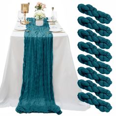 the table is set up with blue yarn and place settings for two people to sit at